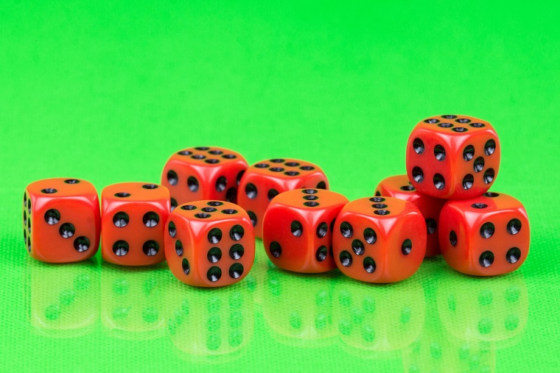 Red dice on green background